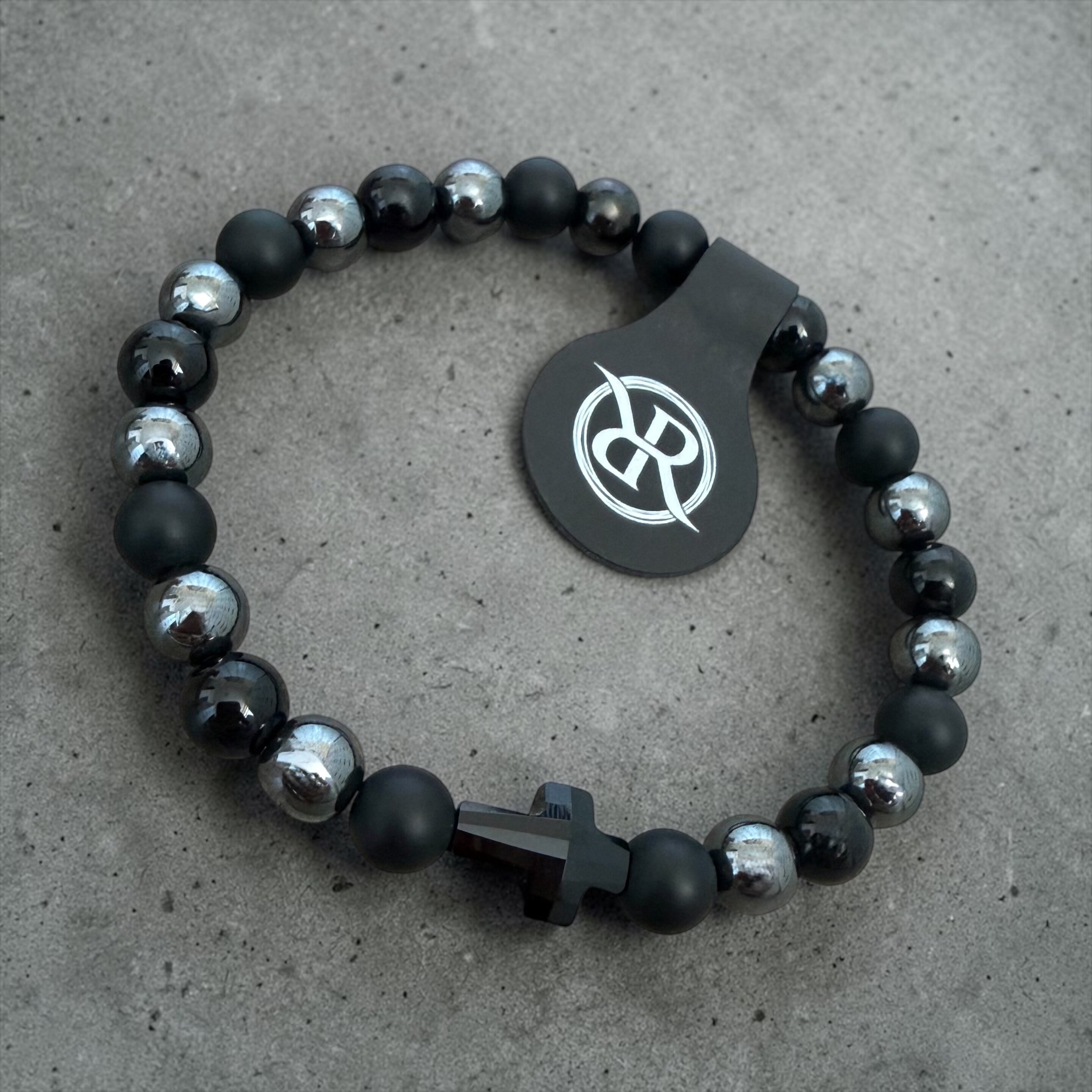 A bracelet made from natural onyx and haematite stones with a black Swarovski cross
