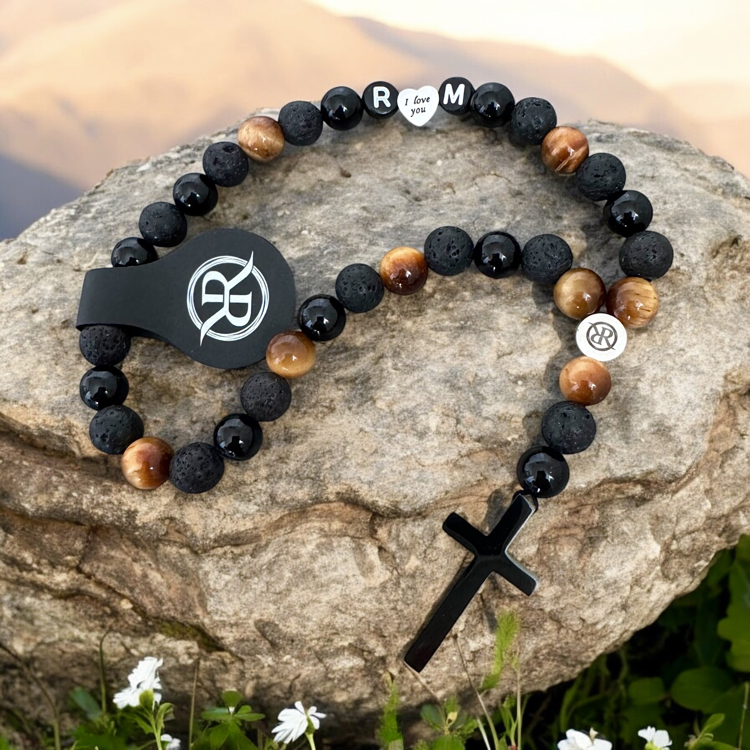 A car rosary for the rear-view mirror, made from natural onyx, lava and tiger’s eye stones, with personalised lettering