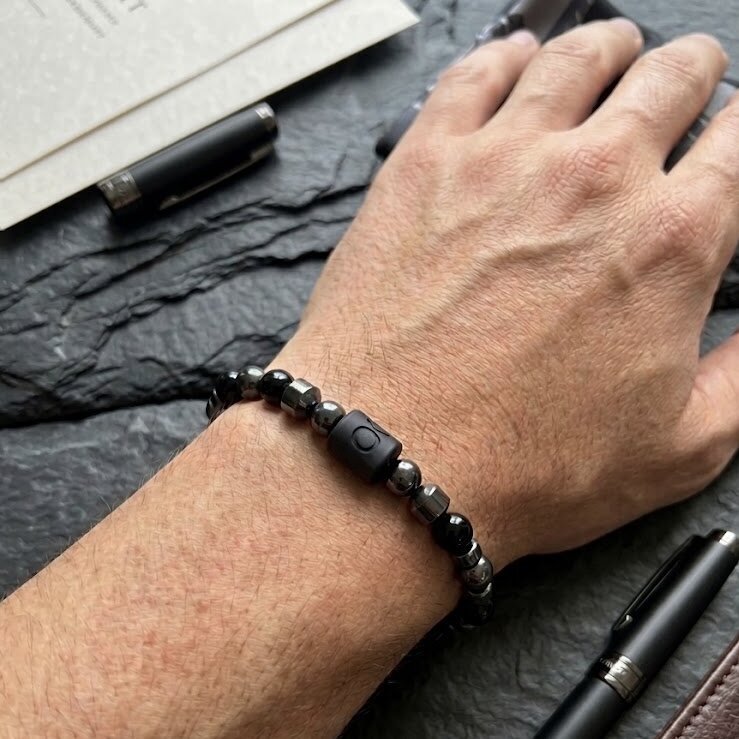 A clasp-fastening bracelet made from natural onyx and haematite stones, featuring a zodiac sign of your choice