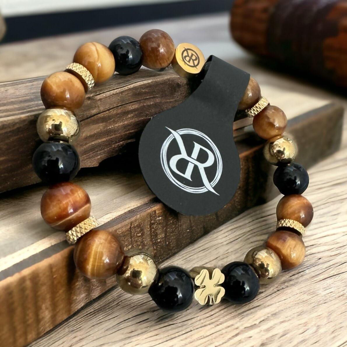 Bracelet made of natural stones with golden four-leaf clover