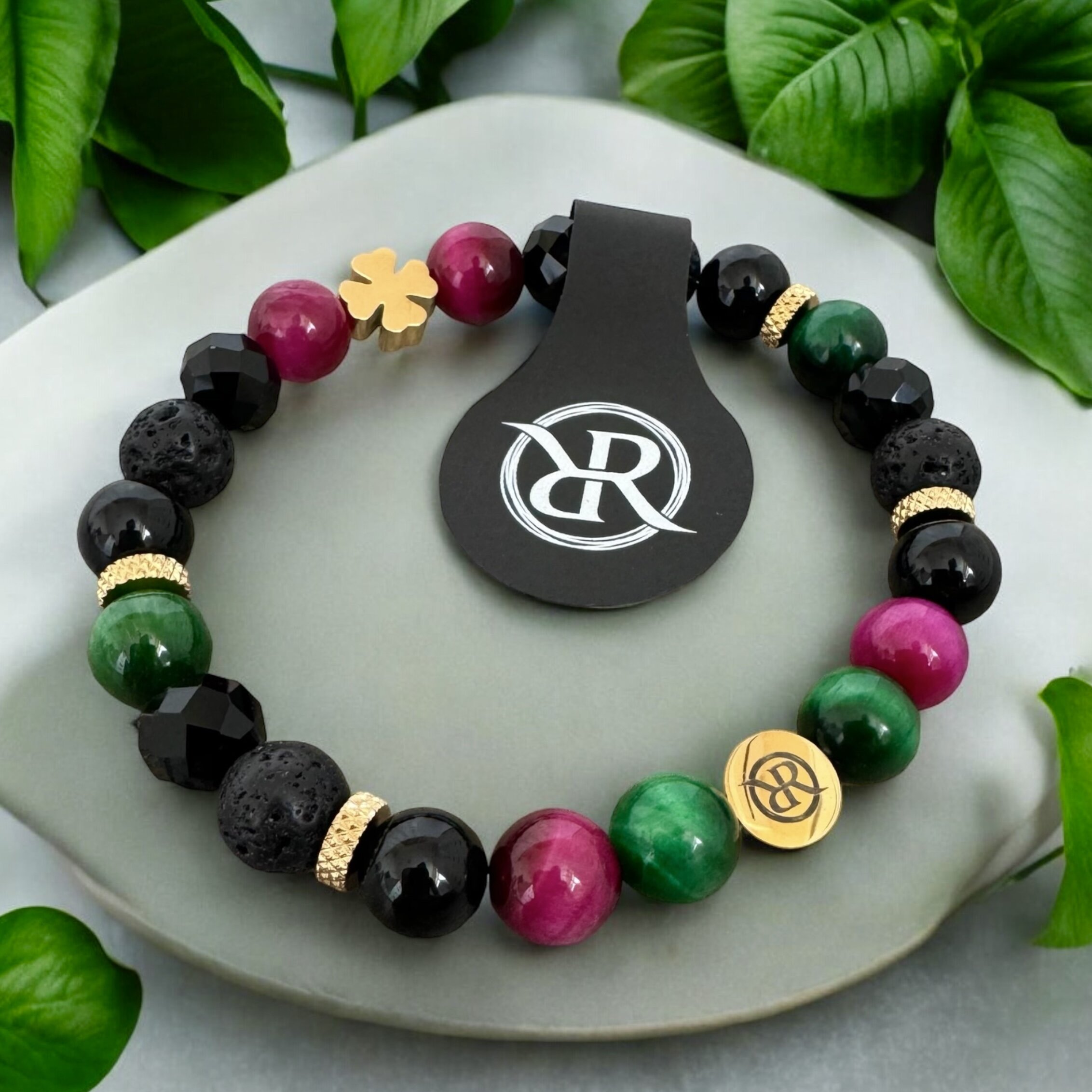 Bracelet made of natural stones with golden four-leaf clover