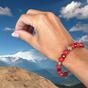 Bracelet made of red coral with four-leaf clover for luck
