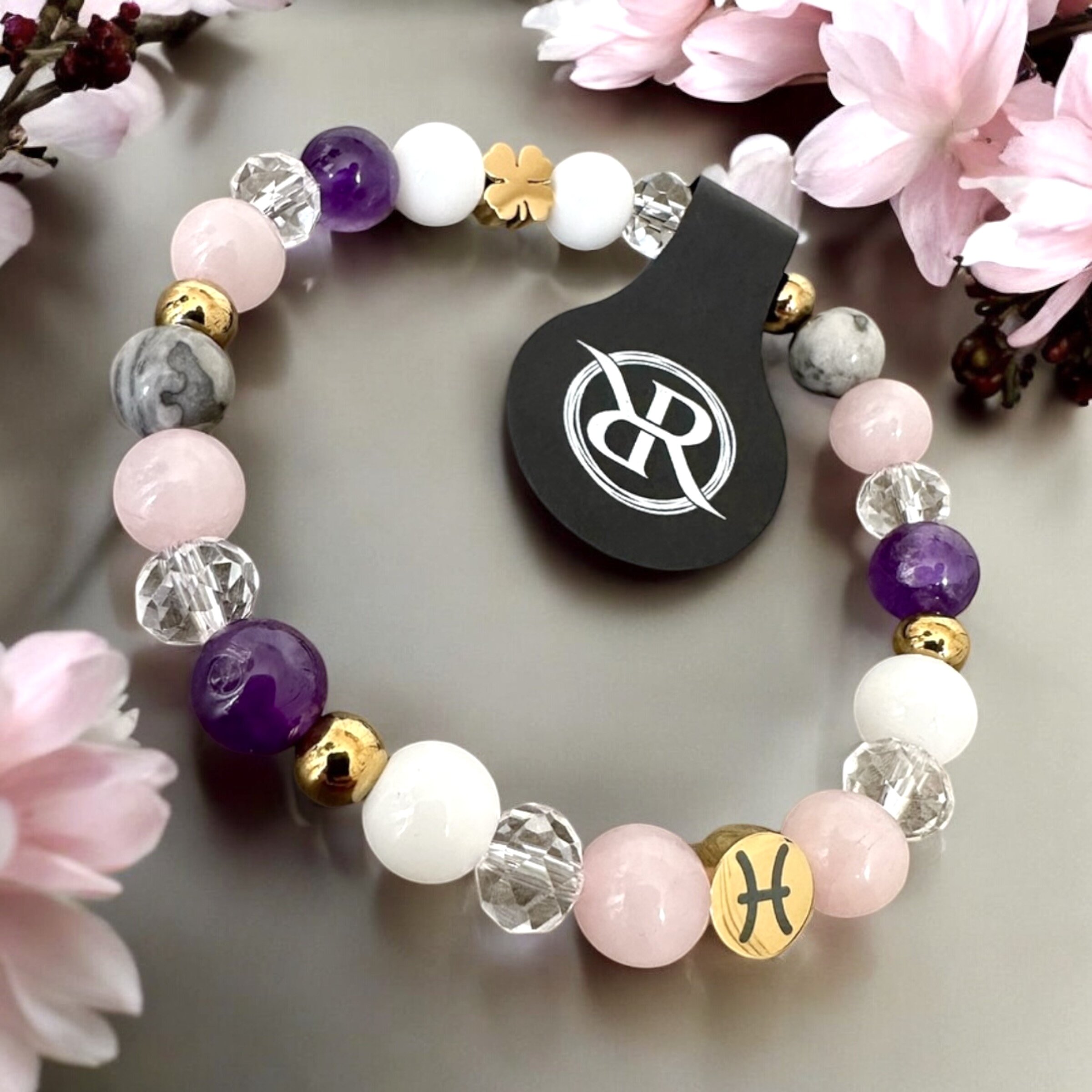 Bracelet with zodiac sign and golden four-leaf clover