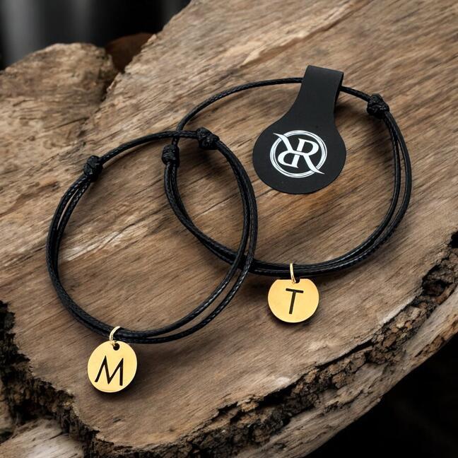 Two minimalist bracelets with gold lettering