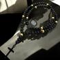 Necklace in the shape of a rosary made of natural stones with a black cross
