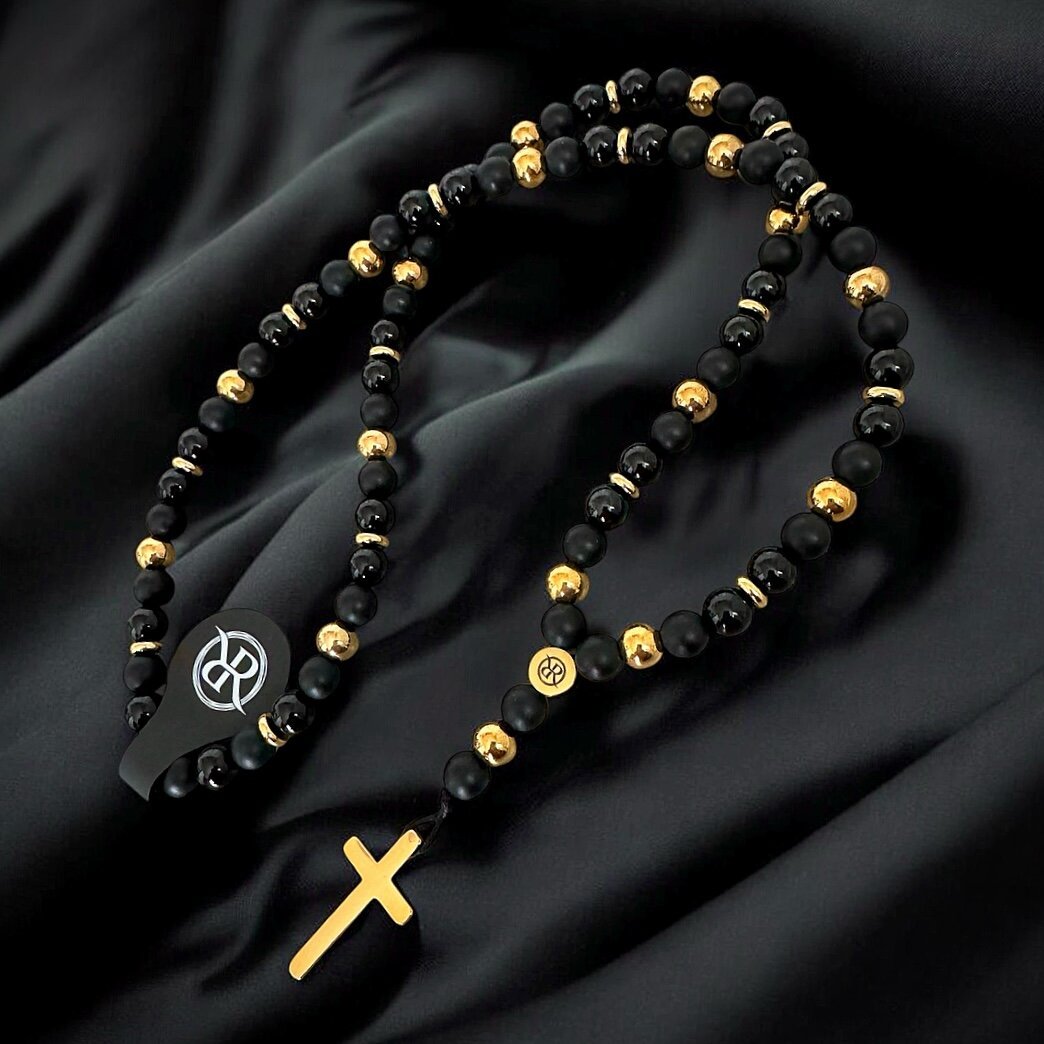 Necklace in the shape of a rosary made of natural stones with a gold cross