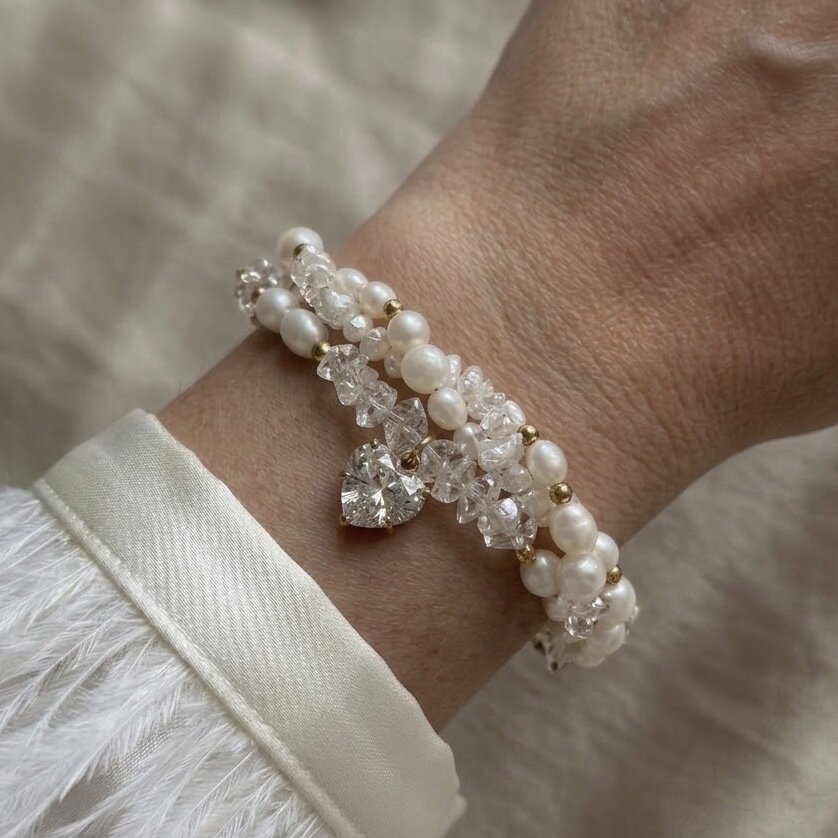 The “Pure love of pearls” bracelet, made from river pearls and clear cut stones, with a heart-shaped pendant